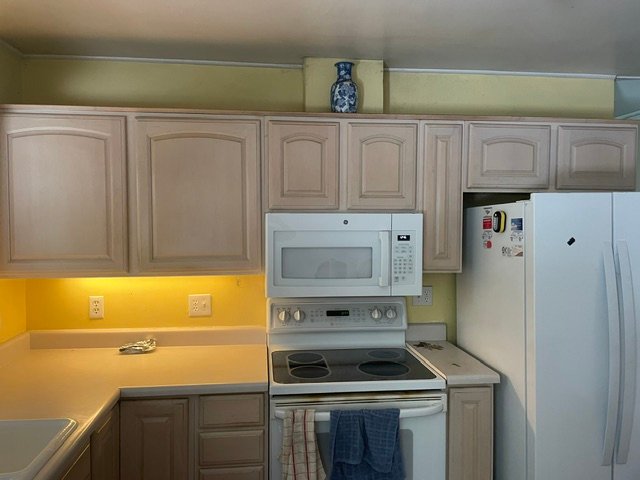 Dated kitchen with tan cabinets before remodel in Denver, CO