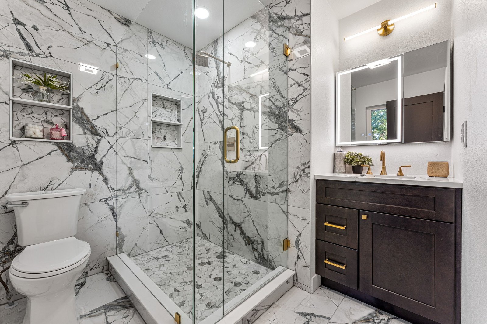 Remodeled bathroom with marble hexagon tile walk-in shower after renovation in Denver, CO